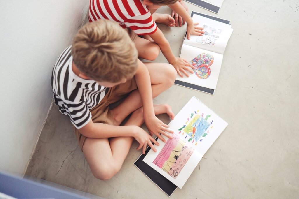 Kids looking at their artwork book