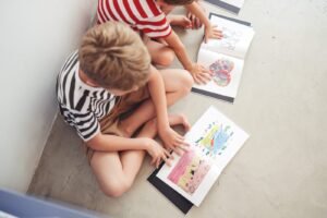 Kids looking at their artwork book